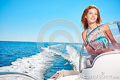 Young woman driving a motor boat Stock Photo