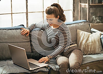 Young woman with dslr photo camera using laptop Stock Photo