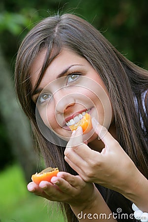Young woman eating apricots Stock Photo