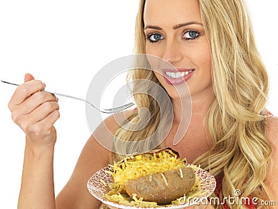 Young Woman Eating a Baked Potato with Cheese Stock Photo