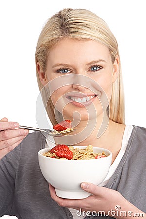 Young Woman Eating Bowl Of Healthy Cereal Stock Photo