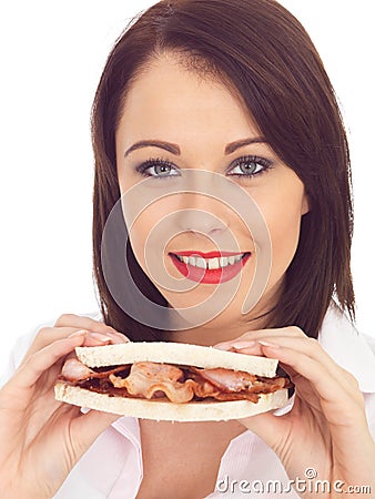 Young Woman Eating Holding a Bacon Sandwich Stock Photo