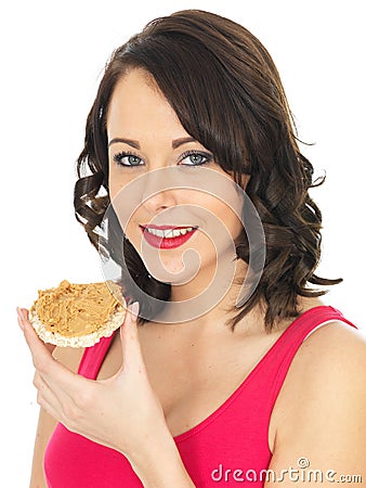 Young Woman Eating Peanut Butter on a Cracker Stock Photo