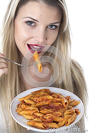 Young Woman Eating Penne Pasta Stock Photo