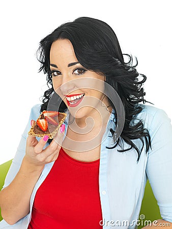 Young Woman Eating Wholegrain Cracker with Chocolate Spread and Fresh Sliced Strawberries Stock Photo