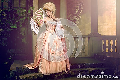 Young woman in eighteenth century image posing in vintage exterior Stock Photo