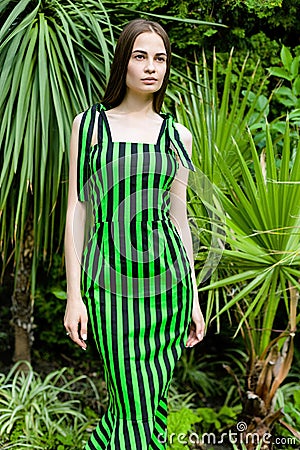 Young woman in elegant striped dress Stock Photo