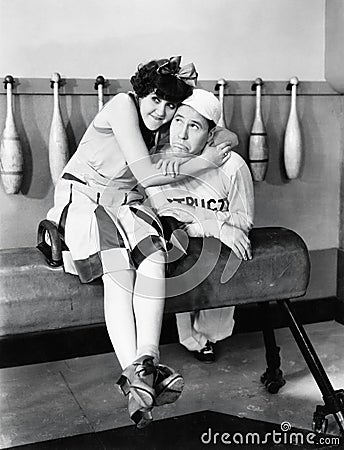 Young woman embracing a young man on a pommel horse Stock Photo