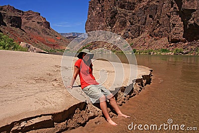 Young woman enjoying the beach above Hance Rapids in the Grand Canyon. Stock Photo