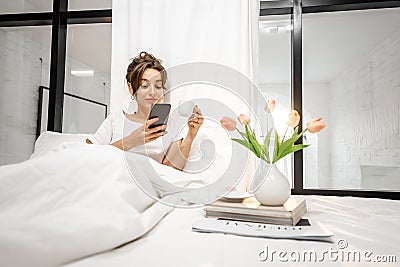 Beautiful woman in sunny bedroom Stock Photo