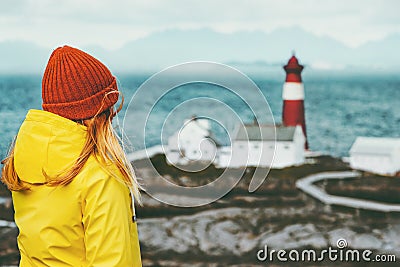 Young woman enjoying Norway lighthouse sea landscape Travel Lifestyle concept adventure scandinavian vacations Stock Photo