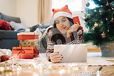 Young woman enjoying shopping online for Christmas Stock Photo