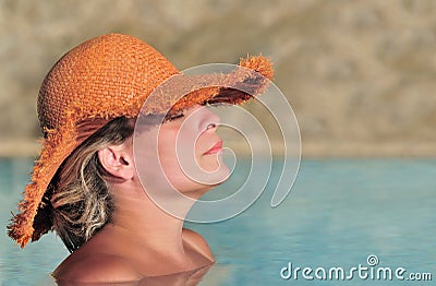Young woman enjoying the sun in the pool Stock Photo