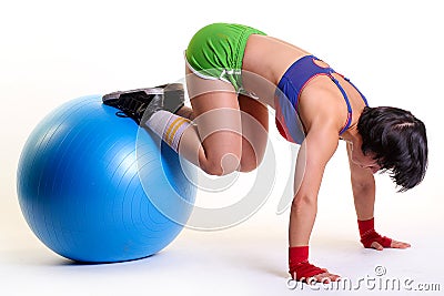 Young woman exercising with fit-ball Stock Photo