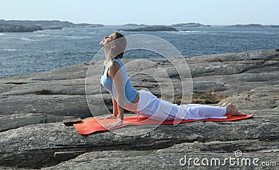 Young woman exercising power yoga Stock Photo