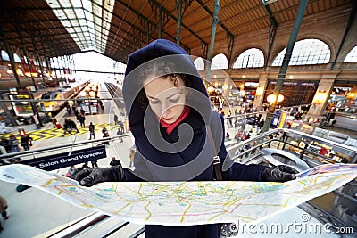 Young woman explores map of Paris Editorial Stock Photo