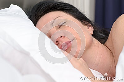 Young woman fast asleep in her bed Stock Photo