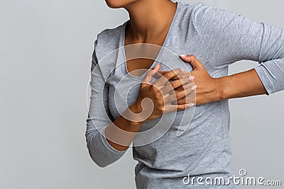 Young woman feel menstrual cyclic breast pain, touching her chest Stock Photo