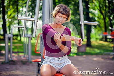 Young woman feeling pain in her elbow, hand during sport workout Stock Photo