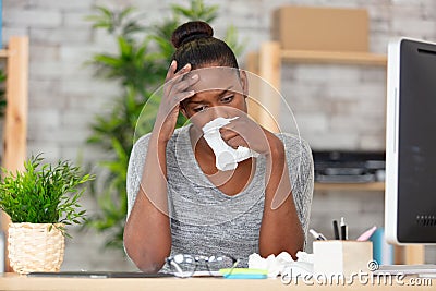 young woman with fever at work Stock Photo