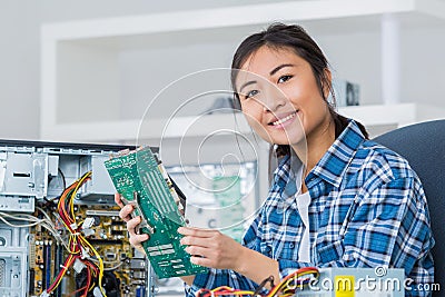 Young woman fixing computer Stock Photo