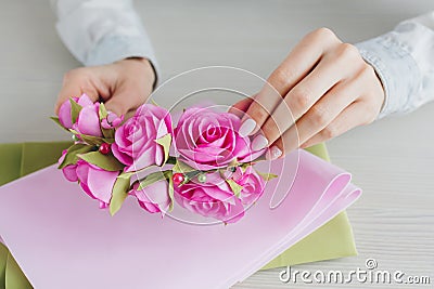 Florist does a wreath with artificial flowers from Foamiran Stock Photo