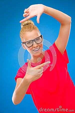 Young Woman Frames Her Face With Fingers. Stock Photo