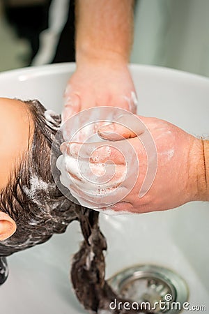 Young woman gets hair wash Stock Photo