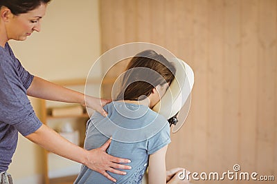 Young woman getting massage in chair Stock Photo