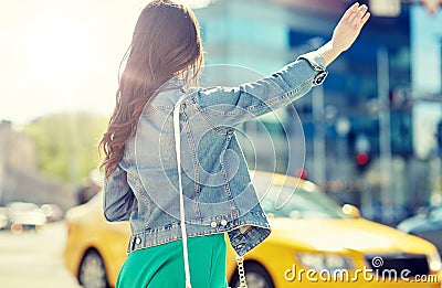 Young woman or girl catching taxi on city street Stock Photo