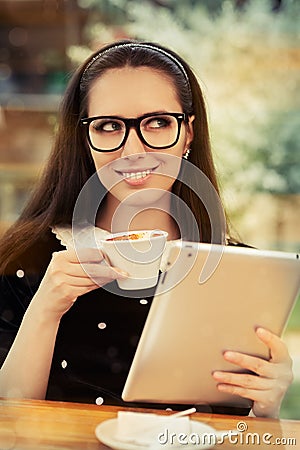 Young Woman with Glasses and Tablet Having Coffee Stock Photo