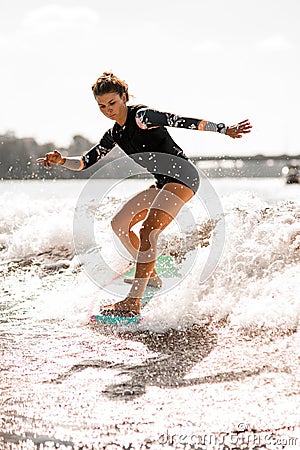 Young woman go in for active water sport with surf style wakeboard Stock Photo