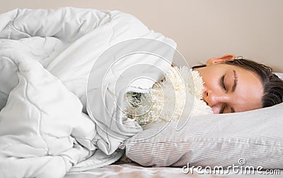 Young woman goes to sleep with teddy bear in her bedroom. Circadian rhythm. Biological clock. Sleep optimisation Stock Photo