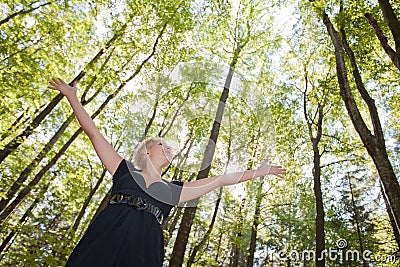 Young woman in green forest Stock Photo