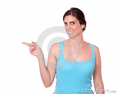 Young woman in gym clothing pointing to her right Stock Photo