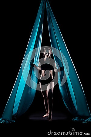 Young woman gymnast with blue gymnastic aerial silks Stock Photo