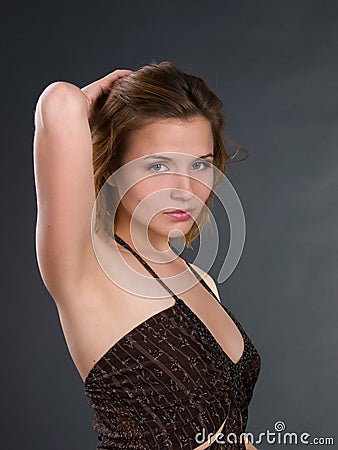 Young woman half-length portait with raised arm. Stock Photo