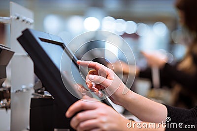 Young woman hand doing process payment on a touchscreen cash register, POS, finance concept Stock Photo