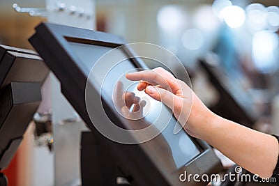 Young woman hand doing process payment on a touchscreen cash register, POS, finance concept Stock Photo
