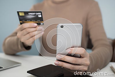 Young woman hand using digital mobile phone scan and payment online with credit card Stock Photo