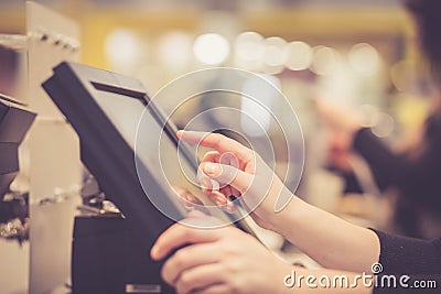 Young woman hands counting, entering discount, sale to a touchscreen cash register, POS, finance concept Stock Photo