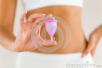 Young woman hands holding menstrual cup on the bathroom. Stock Photo