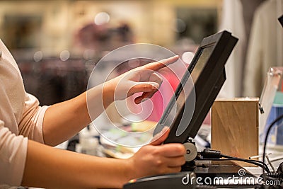 Young woman hands scaning, entering discount, sale on a receipt, touchscreen cash register, shop, finance concept Stock Photo