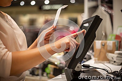 Young woman hands scaning, entering discount, sale on a receipt, touchscreen cash register Stock Photo
