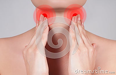 Young woman has sore throat touching the neck Stock Photo