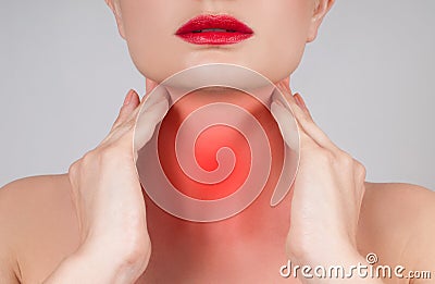 Young woman has sore throat touching the neck Stock Photo