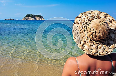 Young woman in hat looking at small island Stock Photo