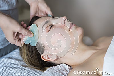 Young woman have face treatment at beauty clinic Stock Photo