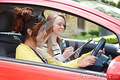 Young Woman Having Driving Lesson With Female Instructor Stock Photo