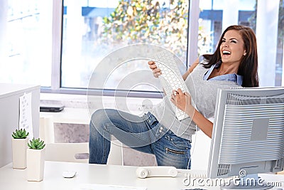 Young woman having fun in bright office Stock Photo